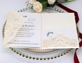 Elegant ivory laser-cut lace wedding invitation set on a white tray with roses - Starry White
