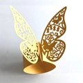 Detailed close-up of golden butterfly laser-cut paper napkin ring with intricate patterns - Gold