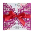 Detail of laser-cut glitter wedding invitation with red ribbon bow and floral insert - Glitter Rose Red