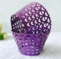 Purple laser cut cupcake wrappers with hollow heart patterns on white plush background - Dark Purple