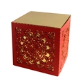 Detail of red hollowed-out wedding favor box with intricate laser-cut floral patterns - Red + Gold