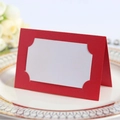 Elegant red laser-cut wedding place card with a white insert on a gold-patterned plate - Pearlescent Red
