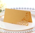 Close-up of laser-cut place card with golden metallic texture for wedding tables - Gold