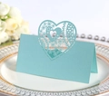 Detail of light blue laser-cut wedding place card with intricate hollow heart lace pattern - Light Blue