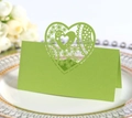 Detail of laser-cut heart seat card in green finish on a decorative white plate - Bright Green