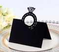 Close-up of laser-cut black place card featuring a diamond ring hollow design on white plate - Black Khaki