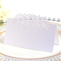 Elegant white laser-cut heart place card on a gold-rimmed plate for wedding table decor - White