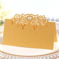Elegant gold laser cut heart place card for weddings on a white porcelain dinner plate - Gold