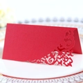 Elegant red laser-cut wedding place card with intricate floral patterns on pearl paper - Pearlescent Red