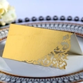 Elegant gold laser-cut wedding place card with intricate floral patterns and folding design - Reflective Gold