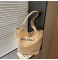 Detailed close-up of blue BALIMAN letter embroidery on beige canvas tote bag - Khaki