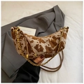 Detailed macro view of the half-moon crossbody bag with animal print and gold chain - Brown