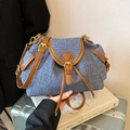 Retro denim and brown leather bucket bag with gold hardware on a silver suitcase - Blue