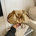 Straw and brown leather drawstring backpack featuring woven texture and metal buckle - Khaki