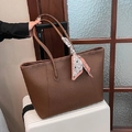 Bolso tote marrón oscuro con textura de lichi y pañuelo decorativo sobre maleta - Marrón