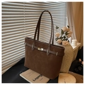 Detailed view of brown suede tote bag featuring a gold buckle and textured leather strap - Brown