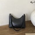 Minimalist black half-moon bucket bag with pleated leather texture and silver hardware - Black (Without Charm)