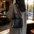 Chic black matte leather bucket bag with boho beaded charm and thin shoulder strap - Black