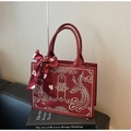 Detail of red Chinese wedding bag with golden dragon embroidery and silk scarf handle - Dragon and Phoenix