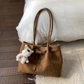 Detail of dark brown suede tote bag with slim straps and a cute plush dog pendant charm - With Pendant / Brown