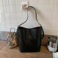 Classic black bucket bag in textured faux leather with long shoulder strap and brown lining - Black