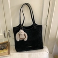 Detail of black suede tote bag with white contrast stitching and plush rabbit charm - Black with Pendant