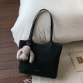 Detail of black suede tote bag with MUTING logo and cute beige plush rabbit charm - Black With Pendant
