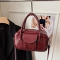 Deep burgundy oil wax leather bowling handbag with silver hardware and adjustable strap - Red