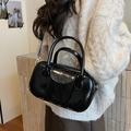 Glossy black bowling bag in oil wax leather with top handles and crossbody strap - Black