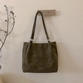 Large olive green suede tote bag with leather straps and metal rings hanging on a wall - Green Without Pendant