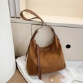 Vintage brown suede hobo bag with smooth leather strap and stylish tassel detail - Caramel color