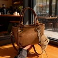 Caramel brown frosted leather tote bag with plush bear charm and adjustable strap - Brown with Pendant