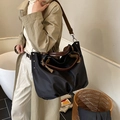 Large black nylon tote bag with brown leather handles and adjustable shoulder strap - Black