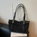 Minimalist black large capacity nylon tote bag with adjustable straps on a stylish sofa - Black