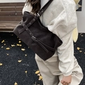 Dark brown matte shoulder bag with metallic buckle and crossover strap detail - Black