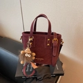 Fashionable dark red PU leather bucket bag with top handles and cute monster charm - Wine Red With Pendant