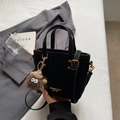 Black suede crossbody bucket bag with golden logo and cute brown monster plush charm - Black with Pendant