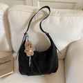 Detail of black leather crescent shoulder bag with a cute brown teddy bear pendant - Black with Pendant