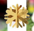Macro view of gold snowflake napkin ring with intricate laser-cut metal texture for Christmas - Reflective Gold