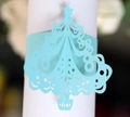 Macro detail of laser cut light blue Christmas tree paper napkin ring with star cutout - Tiffany Blue
