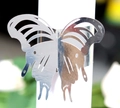 Macro shot of laser-cut silver metal butterfly napkin ring with hollow wings detail - Reflective Silver