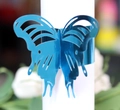 Elegant bright blue laser-cut butterfly napkin ring with hollow metal finish for events - Reflective Blue