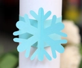 Close-up of light blue laser-cut snowflake paper napkin ring for Christmas decor - Tiffany Blue