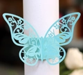 Detail of light blue laser-cut butterfly napkin ring with intricate floral hollow pattern - Tiffany Blue