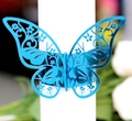 Macro detail of laser-cut bright blue butterfly napkin ring with hollow floral pattern - Reflective Blue