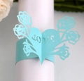 Detail of laser-cut light blue pearlescent paper napkin ring with heart and rose LOVE motif - Tiffany Blue