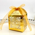 Detail of laser-cut heart pattern on gold metallic candy box with yellow ribbon bow - Reflective Gold