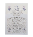Macro detail of laser-cut floral patterns and 3D butterfly on a wedding invitation set - White
