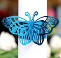 Detail showing the intricate laser-cut butterfly napkin ring in bright royal blue - Reflective Blue