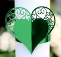 Macro detail of laser-cut green heart napkin ring with intricate filigree patterns - Reflective Green